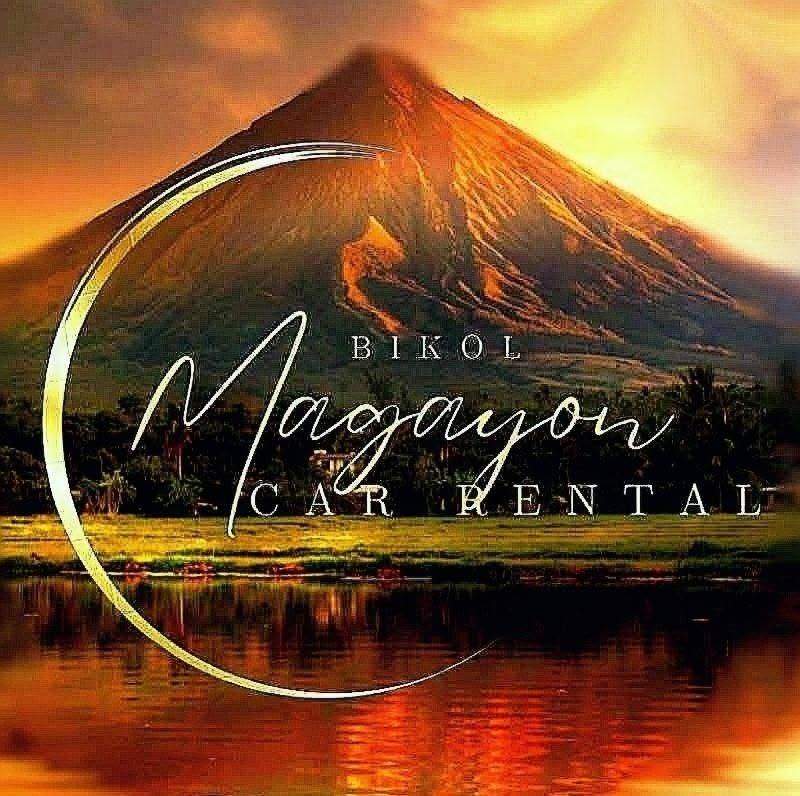 Gray Toyota SUV parked on a coastal road with Mayon Volcano in the background
